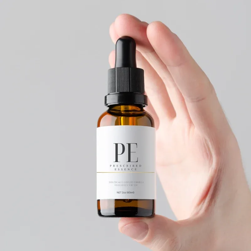 Prescribed Essence | Treatment bottle held in a hand Prescribed Essence | Regrow Your Hair