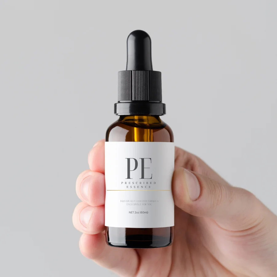 Prescribed Essence | Original bottle close-up in hand Prescribed Essence | Regrow Your Hair